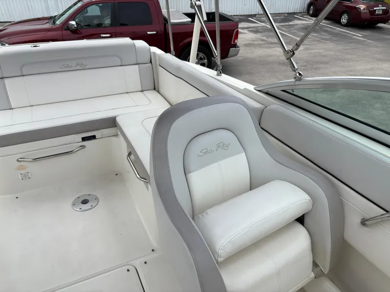 Slide: The Image of 2012 Sea Ray 260 Sundeck boat interior with white seating and steering area. - 15