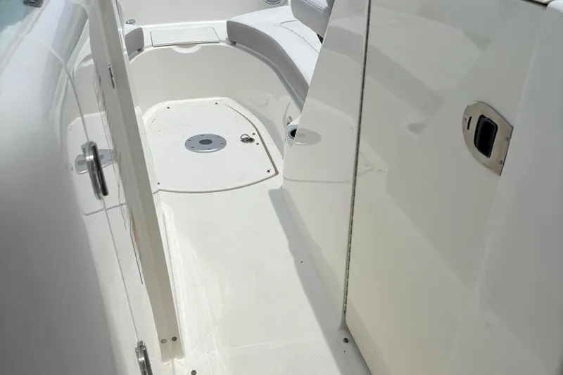 Slide: The Image of 2012 Sea Ray 260 Sundeck interior with white seating and clean deck. - 19