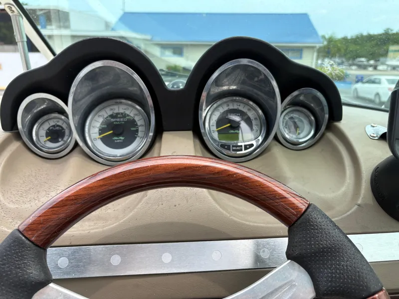 Slide: The Image of Dashboard of a 2012 Sea Ray 260 Sundeck boat with gauges and steering wheel. - 20