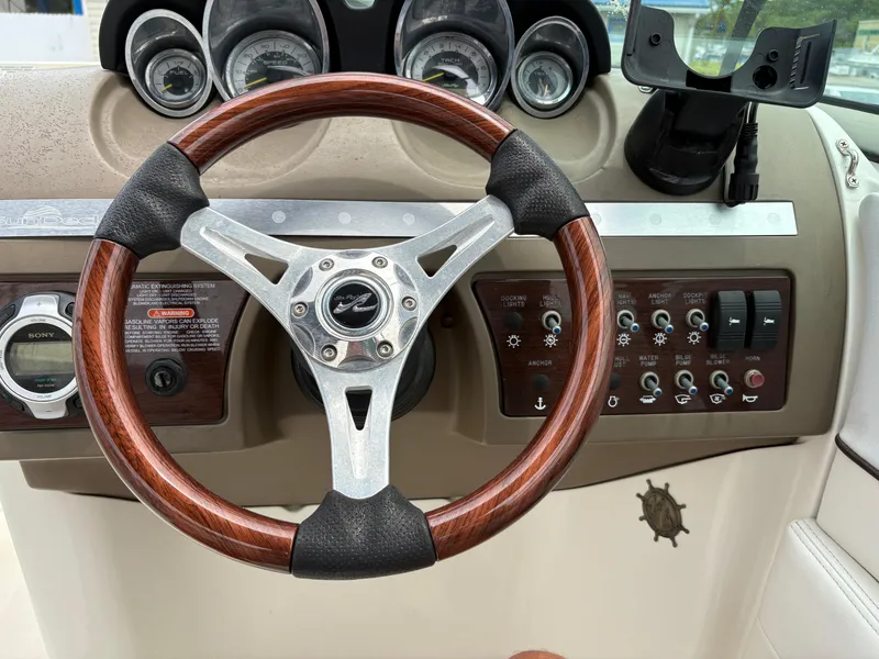 Slide: The Image of Steering wheel and dashboard of a 2012 Sea Ray 260 Sundeck boat. - 21