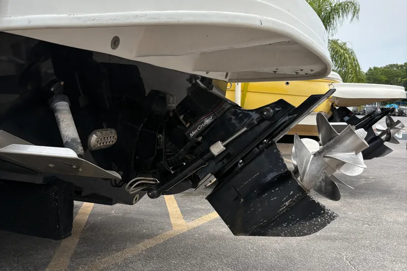 Slide: The Image of 2012 Sea Ray 260 Sundeck boat with dual propellers and outboard motor. - 26