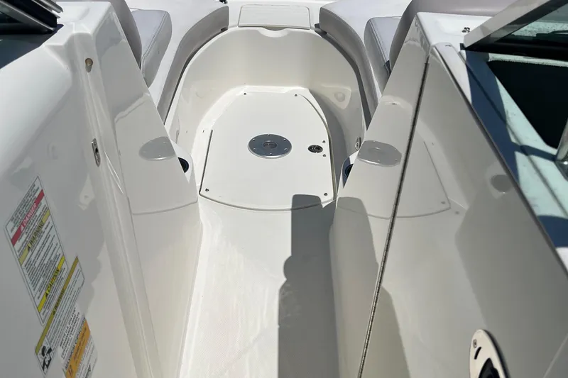 Slide: The Image of 2012 Sea Ray 260 Sundeck interior, featuring sleek white seating and spacious deck layout. - 31