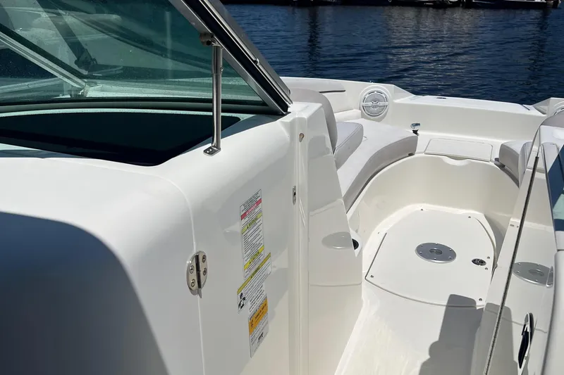 Slide: The Image of 2012 Sea Ray 260 Sundeck boat interior with white seating and open deck. - 32