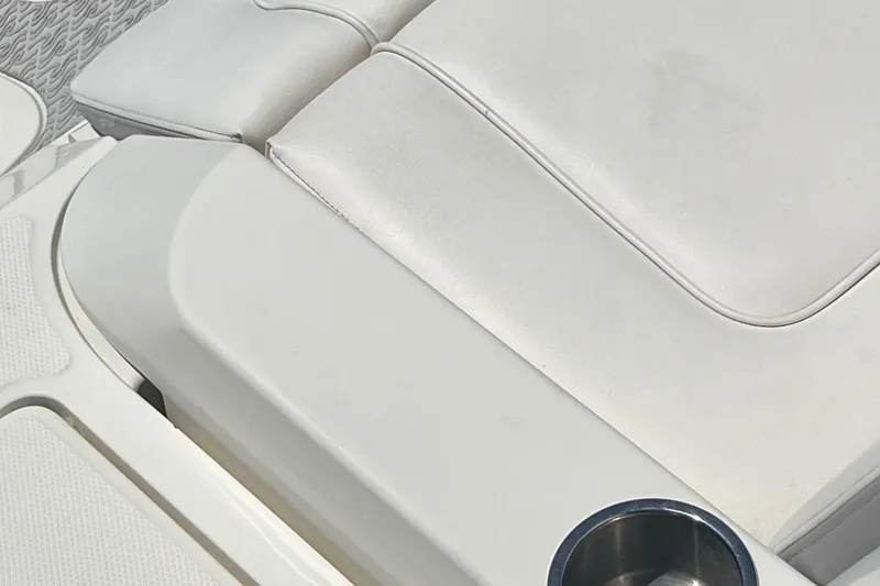 Slide: The Image of White leather seating with cup holder on 2012 Sea Ray 260 Sundeck boat. - 35