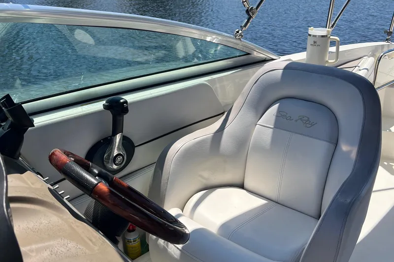 Slide: The Image of Captain's seat of a 2012 Sea Ray 260 Sundeck boat with steering wheel. - 36