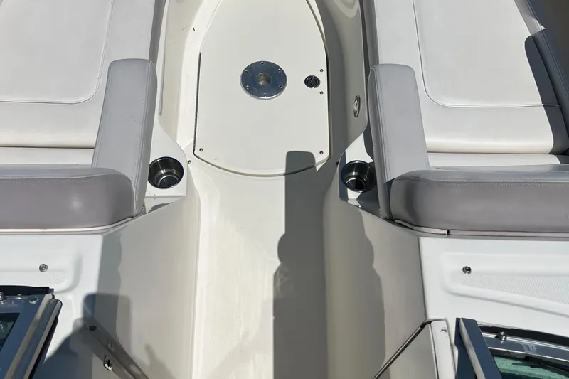 Slide: The Image of 2012 Sea Ray 260 Sundeck interior with white and gray seating, cup holders, and deck details. - 37