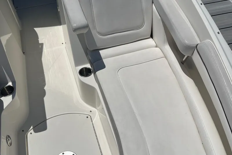 Slide: The Image of 2012 Sea Ray 260 Sundeck interior seating with cup holders, showcasing luxury and comfort. - 38