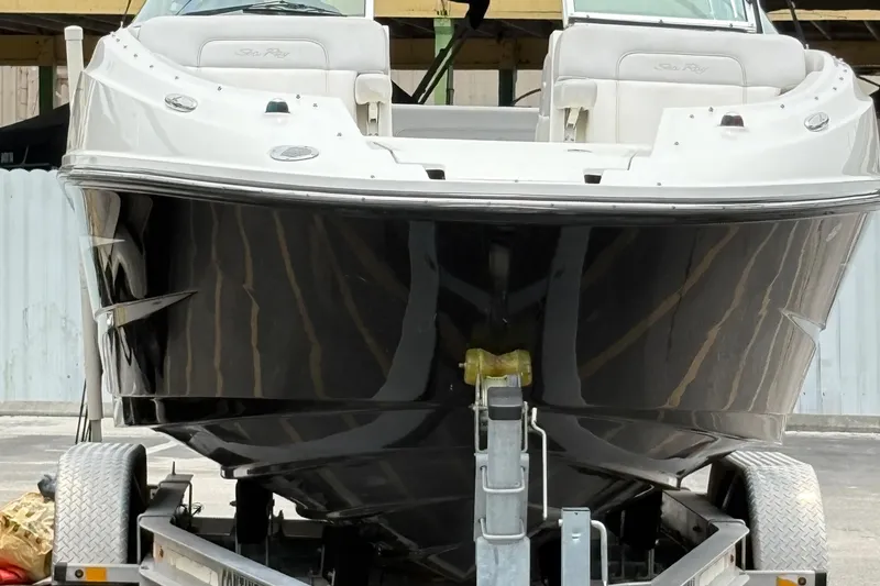 Slide: The Image of 2012 Sea Ray 260 Sundeck boat on trailer, front view, black hull, white interior. - 7