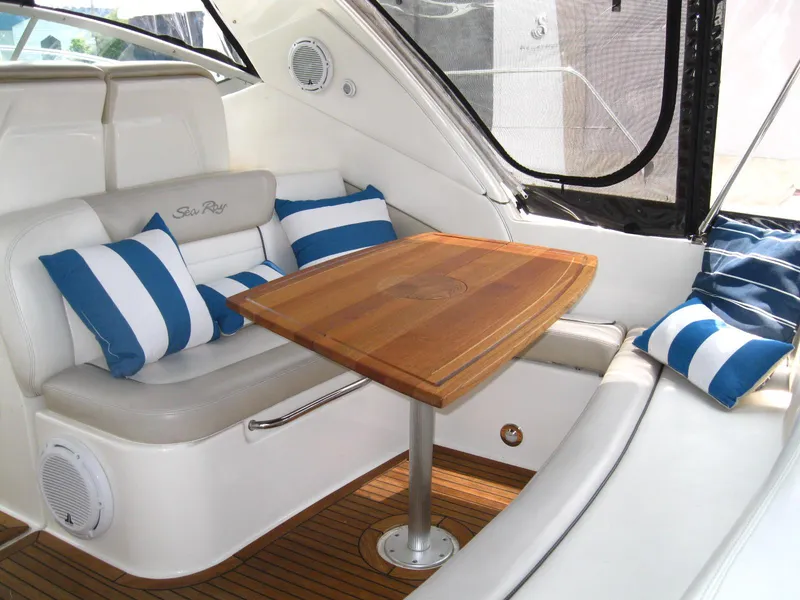 Slide: The Image of Luxurious interior of 2011 Sea Ray 350 Sundancer with striped cushions and wooden table. - 10