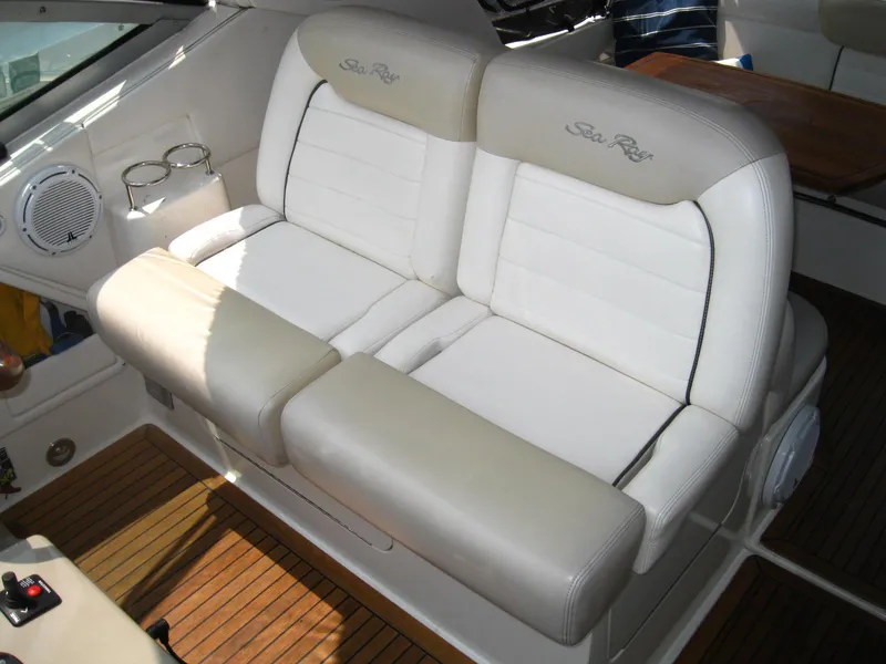 Slide: The Image of Luxurious seating on 2011 Sea Ray 350 Sundancer boat with white upholstery and wood flooring. - 18