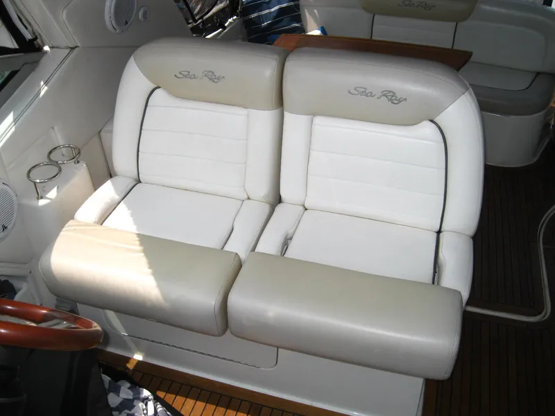 Slide: The Image of 2011 Sea Ray 350 Sundancer interior with white leather seating and wooden flooring. - 19