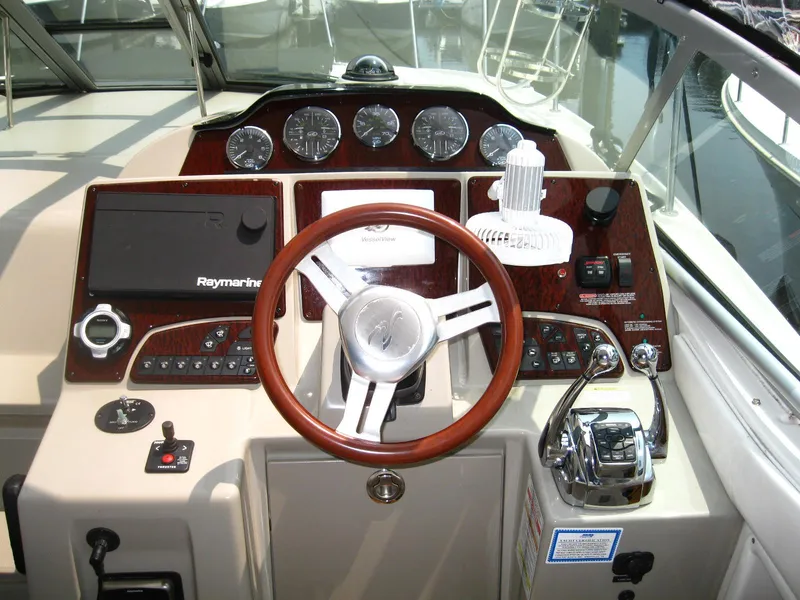 Slide: The Image of Cockpit of 2011 Sea Ray 350 Sundancer with steering wheel and navigation controls. - 20