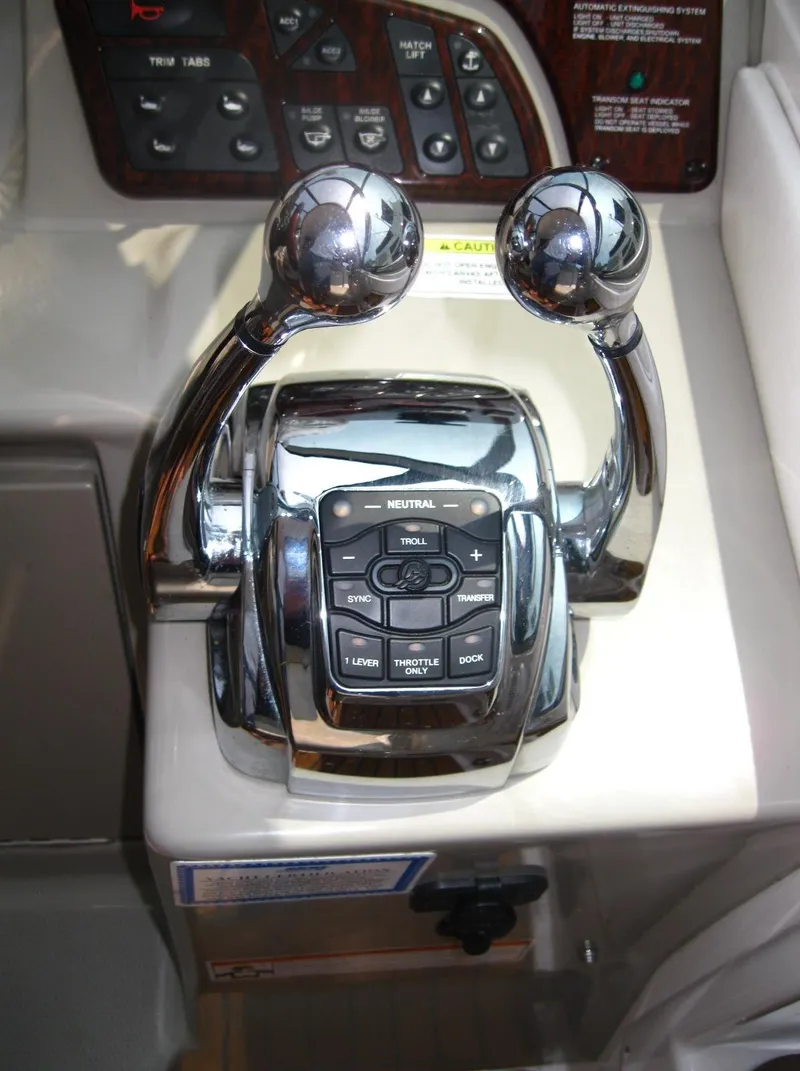 Slide: The Image of Chrome throttle controls on 2011 Sea Ray 350 Sundancer boat dashboard. - 24