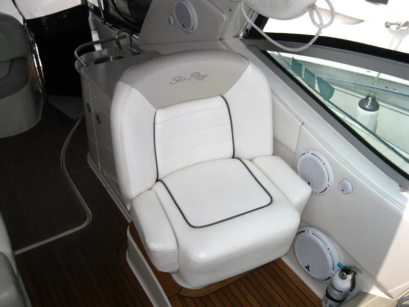 Slide: The Image of Luxury seating on 2011 Sea Ray 350 Sundancer yacht, featuring white upholstery and wood flooring. - 25