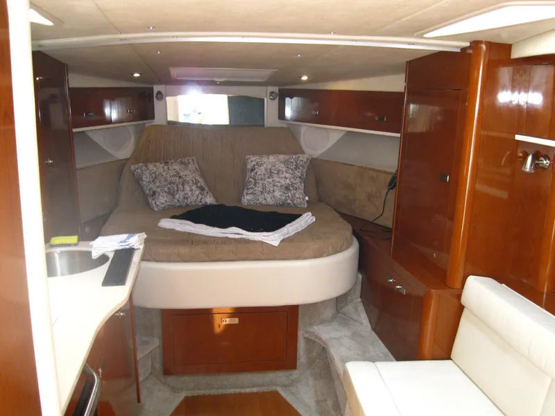 Slide: The Image of Interior of 2011 Sea Ray 350 Sundancer with cozy bed and wooden cabinetry. - 27