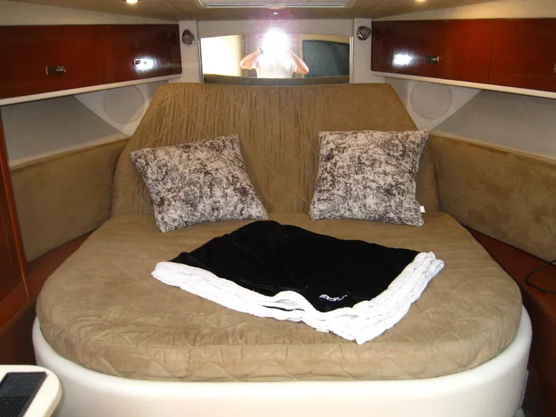 Slide: The Image of Interior cabin of 2011 Sea Ray 350 Sundancer with cozy bed and pillows. - 29