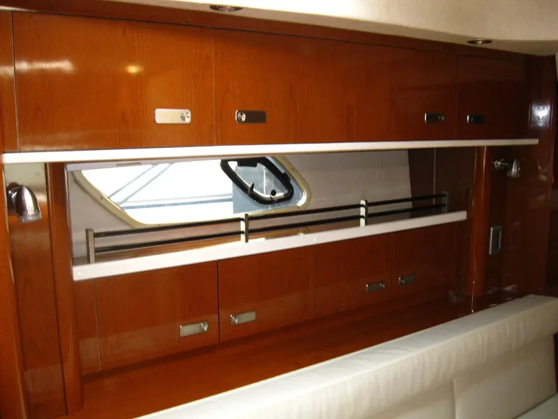 Slide: The Image of Interior of 2011 Sea Ray 350 Sundancer with wooden cabinetry and window. - 33