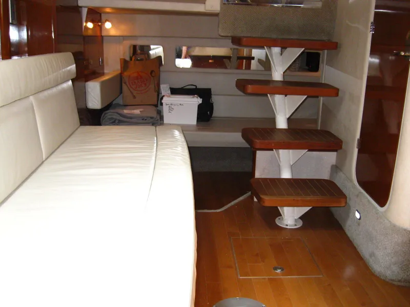 Slide: The Image of Interior of 2011 Sea Ray 350 Sundancer yacht with wooden steps and white seating. - 38