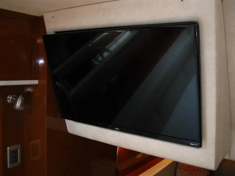 Slide: The Image of Flat-screen TV mounted inside 2011 Sea Ray 350 Sundancer yacht interior. - 39
