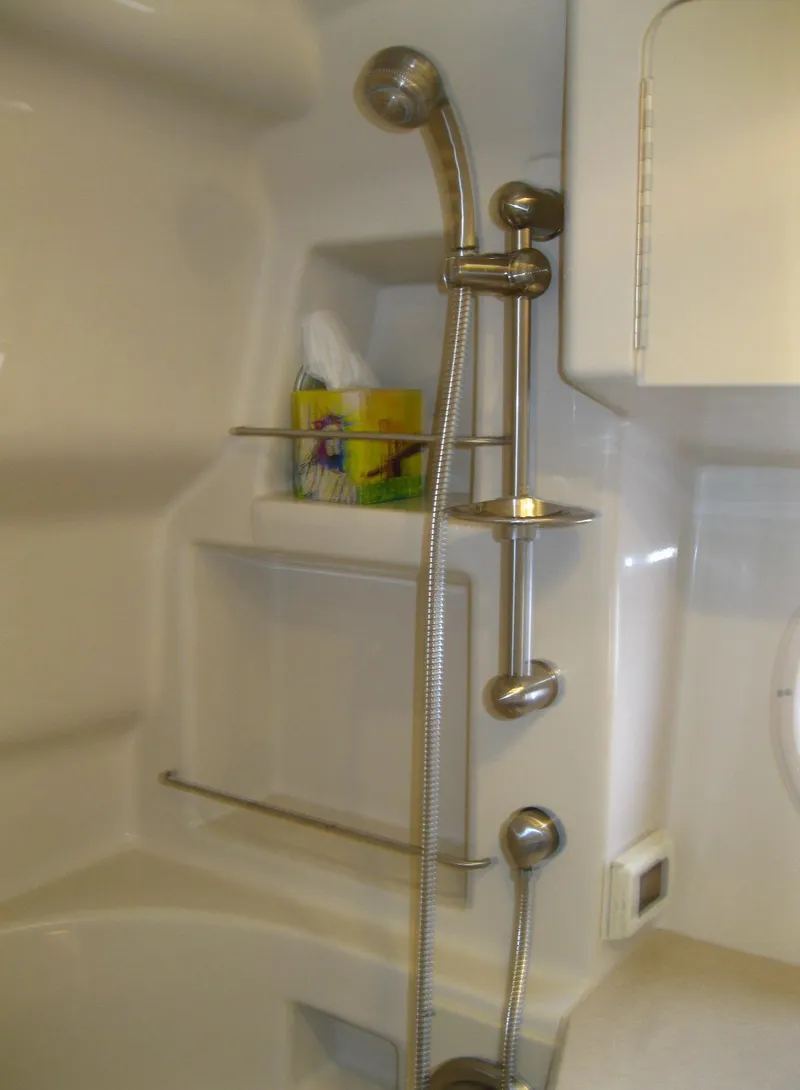 Slide: The Image of Shower area in 2011 Sea Ray 350 Sundancer yacht, featuring modern fixtures and storage shelves. - 43
