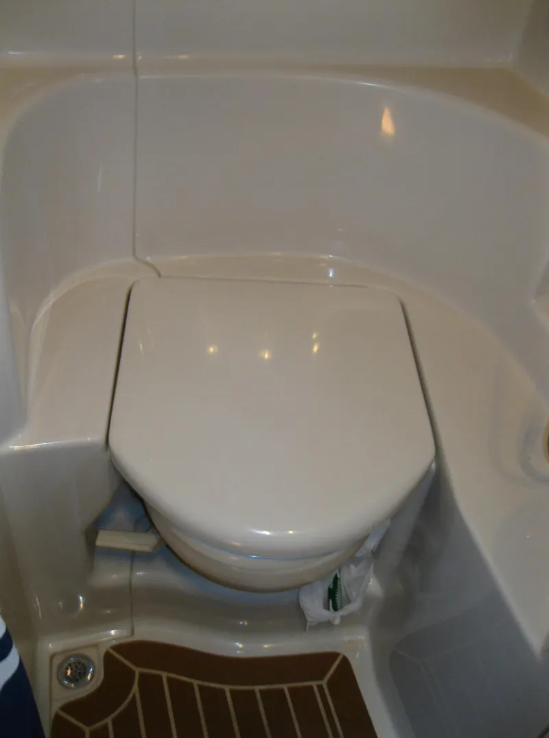 Slide: The Image of 2011 Sea Ray 350 Sundancer boat bathroom with closed toilet lid. - 44