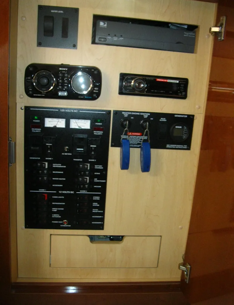 Slide: The Image of Control panel inside 2011 Sea Ray 350 Sundancer, featuring various switches and electronic components. - 45