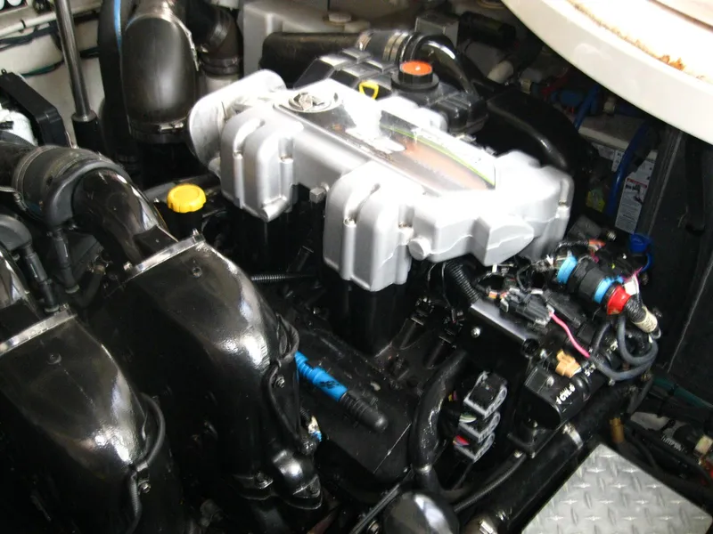 Slide: The Image of Engine compartment of a 2011 Sea Ray 350 Sundancer boat, showcasing mechanical components. - 48