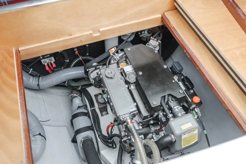Slide: The Image of Engine compartment of a 2016 Lagoon 450F catamaran, showcasing mechanical components and wiring. - 19