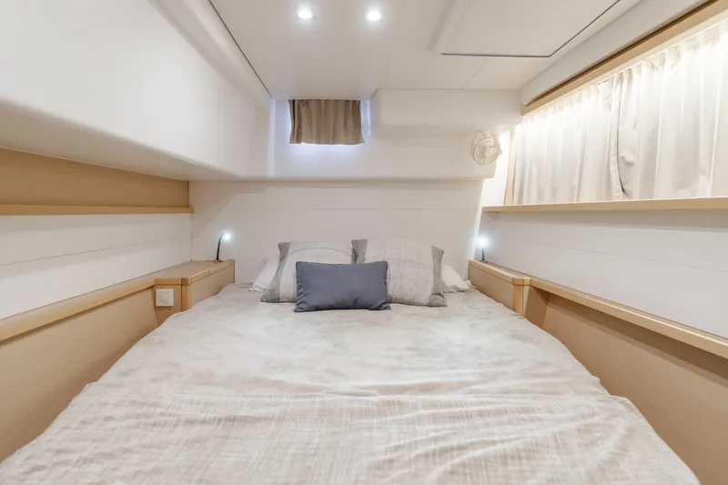 Slide: The Image of Luxurious cabin interior of 2016 Lagoon 450F catamaran with cozy bedding and ambient lighting. - 23