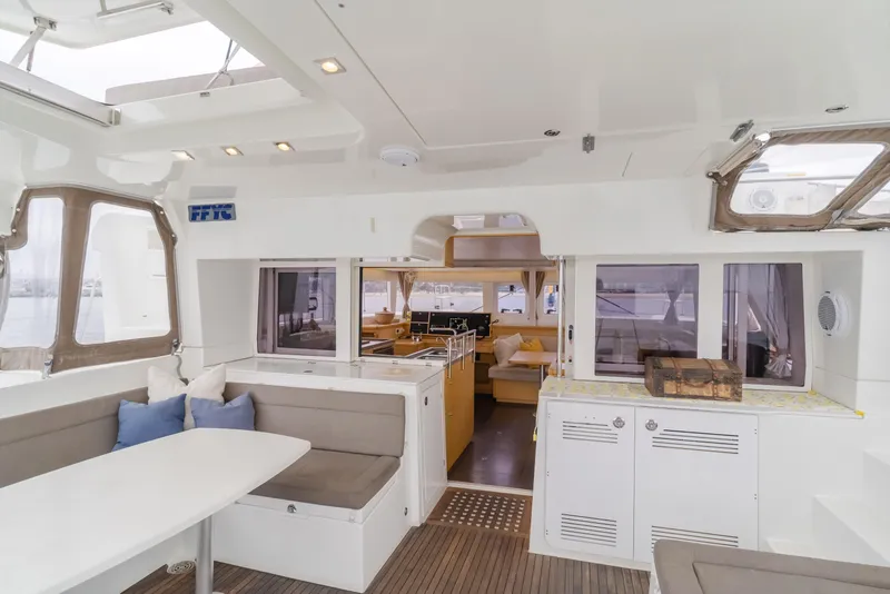 Slide: The Image of Interior of 2016 Lagoon 450F catamaran, featuring modern seating and dining area. - 3