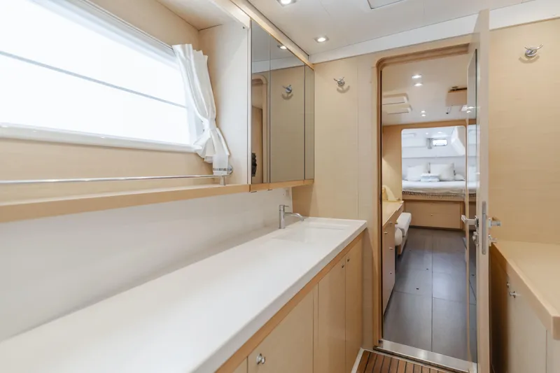 Slide: The Image of Luxurious interior of 2016 Lagoon 450F yacht, featuring a spacious bathroom and bedroom. - 37