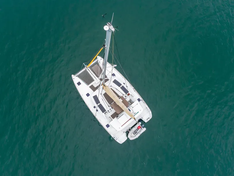 Slide: The Image of Aerial view of 2016 Lagoon 450F catamaran sailing on clear blue water. - 5