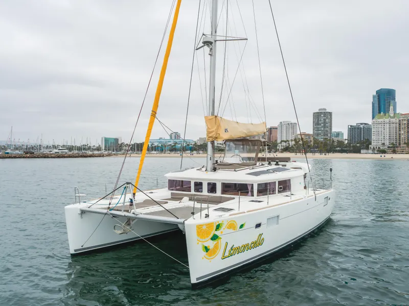 Slide: The Image of Lagoon 450F catamaran 2016 on water near city skyline, overcast sky. - 6