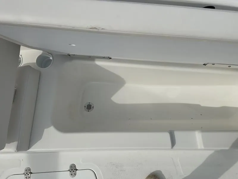 Slide: The Image of 2025 Tahoe T18 boat interior, featuring a clean, white storage compartment. - 11