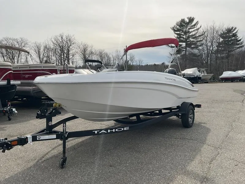 Slide: The Image of 2025 Tahoe T18 boat on trailer with red canopy, parked outdoors. - 6