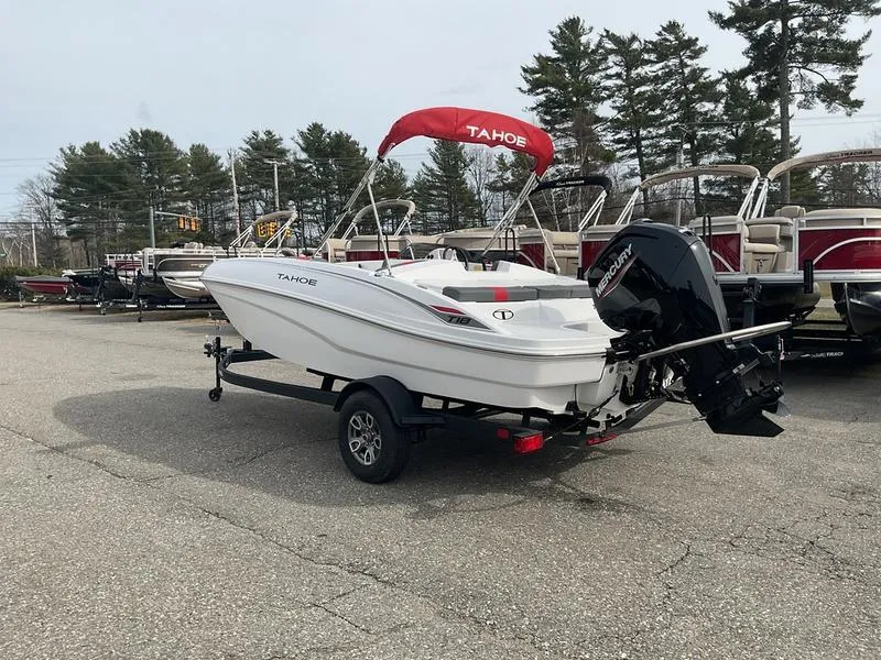 Slide: The Image of 2025 Tahoe T18 boat on trailer with red canopy, parked outdoors. - 7