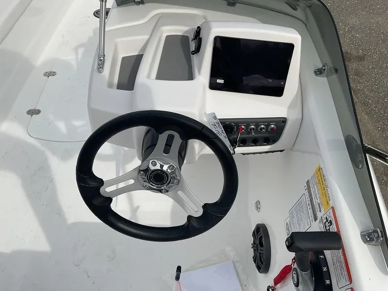 Slide: The Image of 2025 Tahoe T18 boat dashboard with steering wheel and control panel. - 9