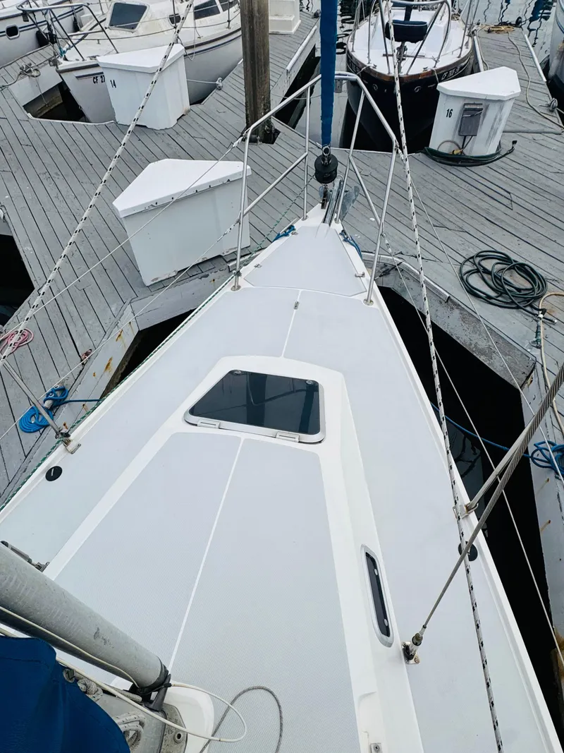 Slide: The Image of 1994 Catalina 320 sailboat docked at marina, view of deck and rigging. - 10
