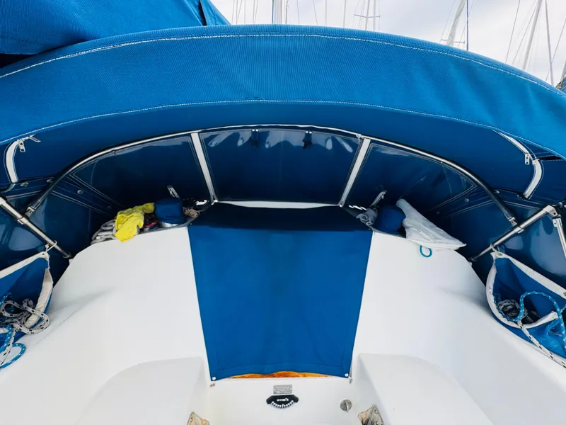 Slide: The Image of 1994 Catalina 320 sailboat cockpit with blue canopy and seating area. - 17