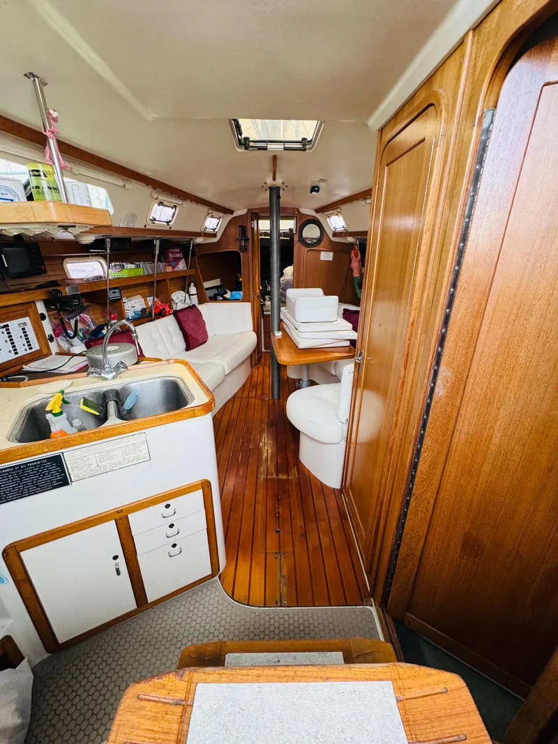 Slide: The Image of Interior of a 1994 Catalina 320 sailboat with wooden finishes and cozy seating. - 18