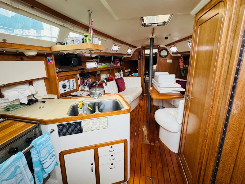 Slide: The Image of Interior of a 1994 Catalina 320 sailboat with wooden finishes and cozy seating area. - 19