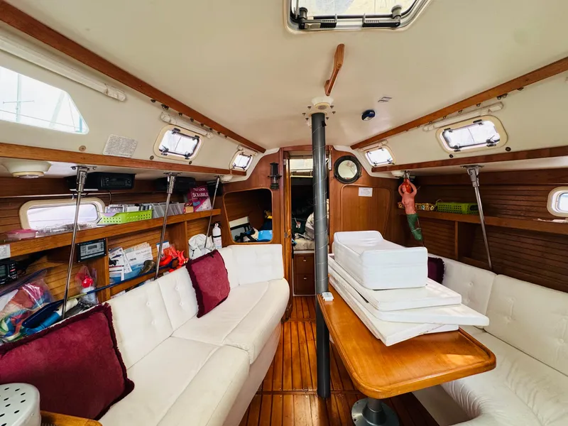 Slide: The Image of Interior of a 1994 Catalina 320 sailboat with cozy seating and wooden accents. - 20
