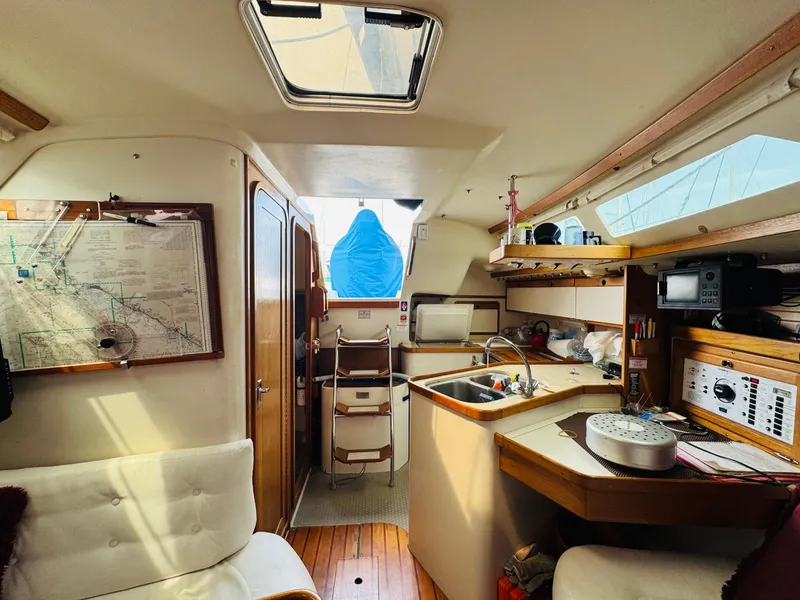 Slide: The Image of Interior of a 1994 Catalina 320 sailboat with cozy seating and navigation area. - 27