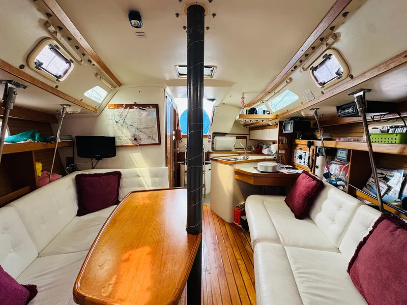 Slide: The Image of Interior of a 1994 Catalina 320 sailboat with cozy seating and wooden accents. - 29
