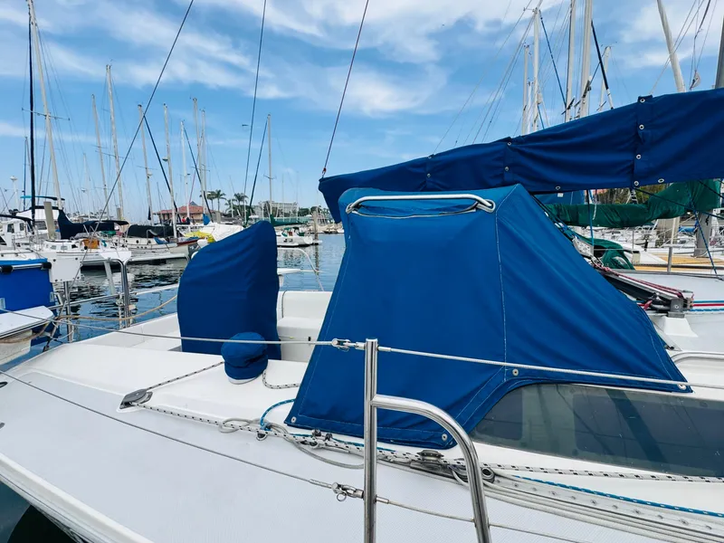 Slide: The Image of 1994 Catalina 320 sailboat docked in marina with blue covers and clear sky. - 7