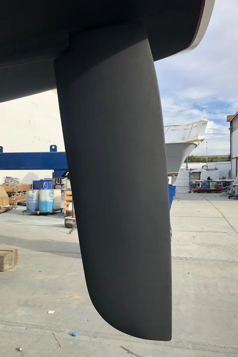 Slide: The Image of Close-up of a C&C 121 sailboat rudder, 2001 model, in a boatyard setting. - 10