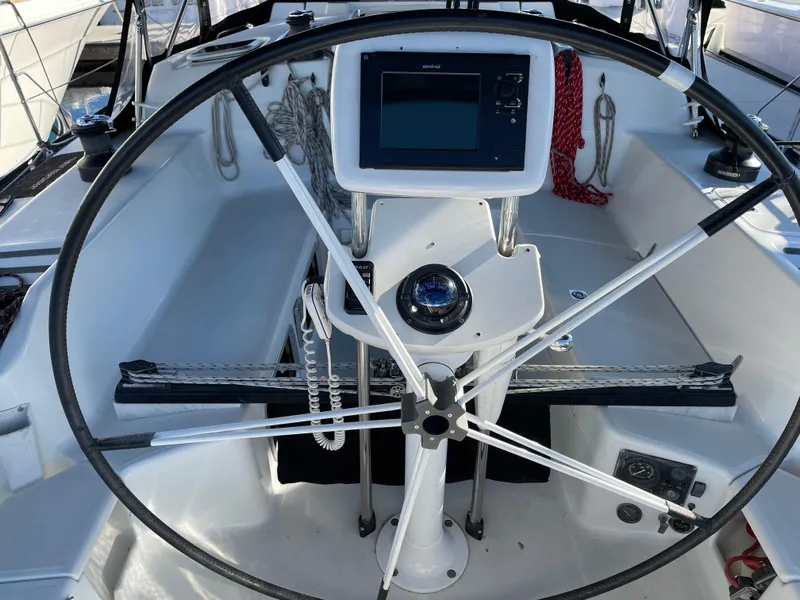 Slide: The Image of Steering wheel and navigation system of a 2001 C&C 121 sailboat cockpit. - 14