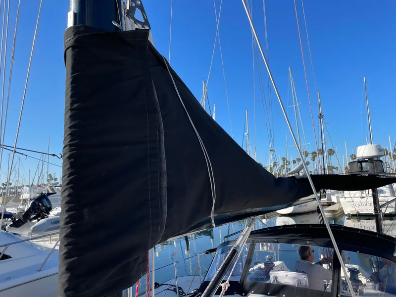 Slide: The Image of Sailboat mast and boom with black sail cover, C&C 121, 2001 model, docked in marina. - 22