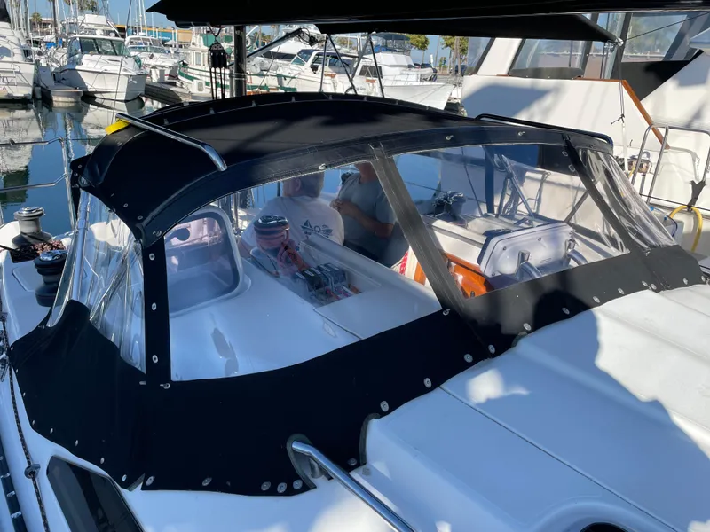 Slide: The Image of Sailboat with black canopy docked at marina, C&C 121 model, 2001. - 25
