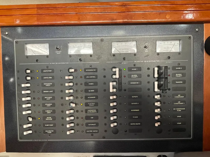 Slide: The Image of Electrical control panel on a 2001 C&C 121 yacht, featuring switches and meters. - 38